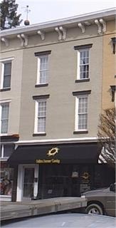 A building with a black awning and a gold logo.