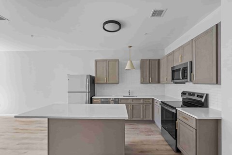 A modern kitchen with a large island in the center.