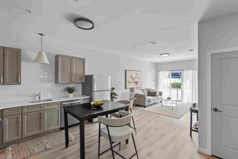 A modern kitchen with a dining table and chairs.