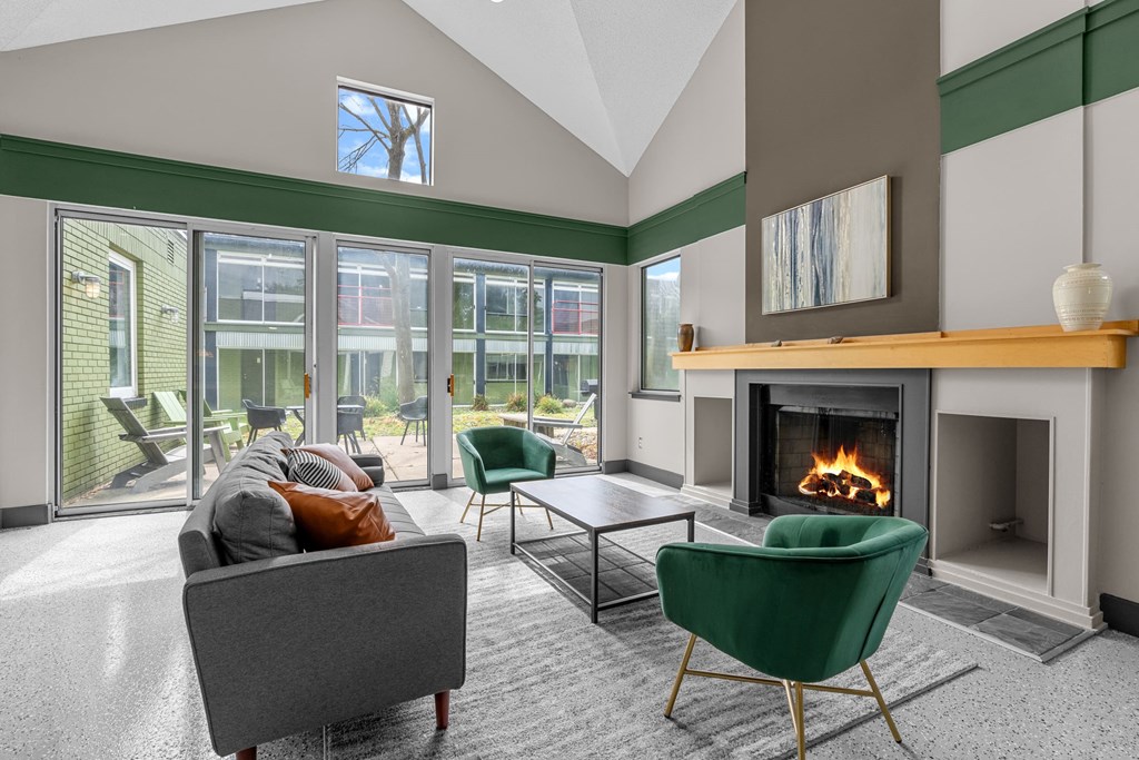 A living room with a fireplace and a green chair.