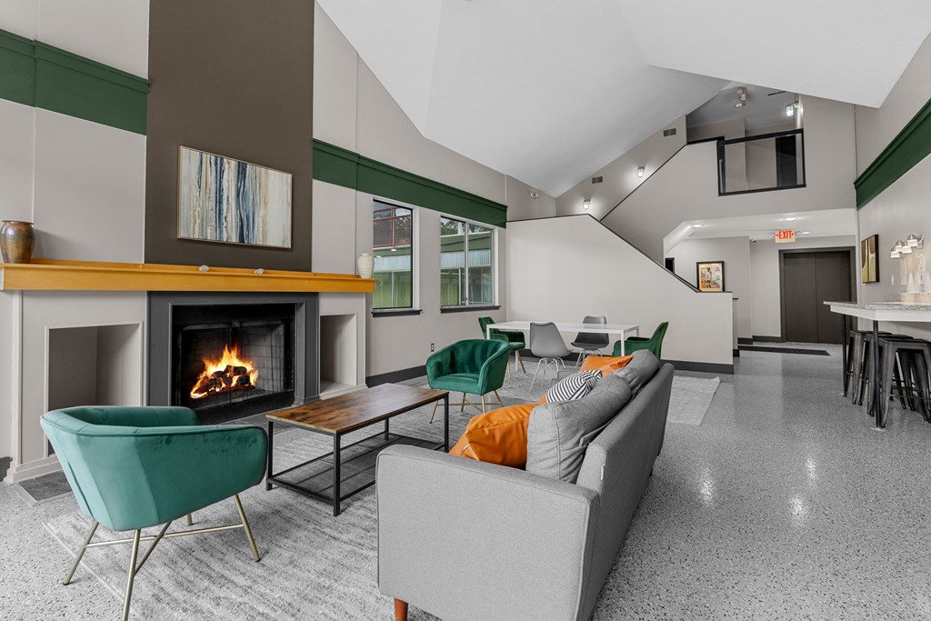 A living room with a fireplace and a green chair.