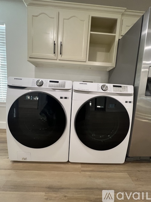 Two front load washing machines in a laundry room.