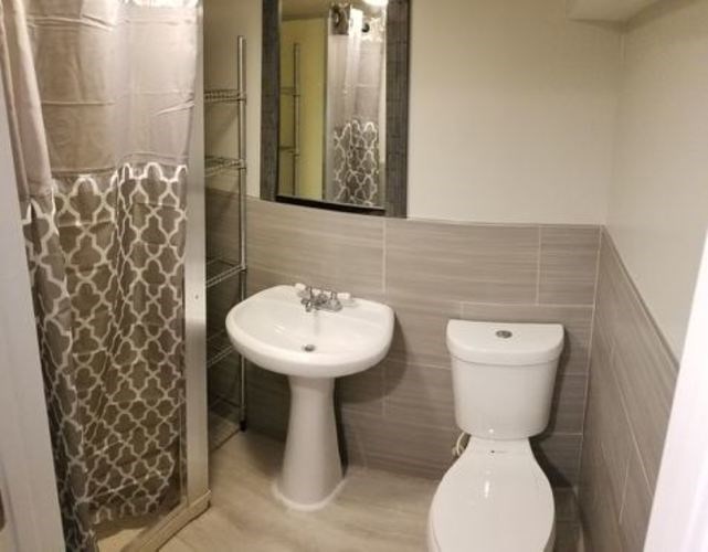 A white sink and toilet in a bathroom.
