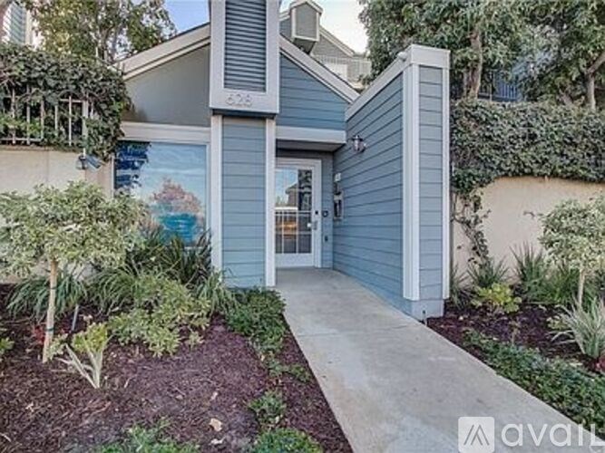 A small blue building with a white door and a small porch.