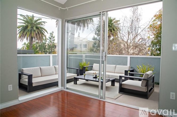 A living room with a glass door and a white couch.