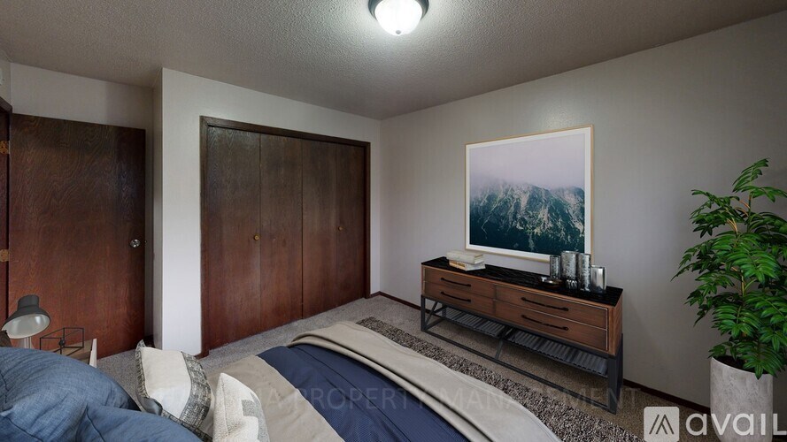 A bedroom with a bed, nightstand, and a painting on the wall.