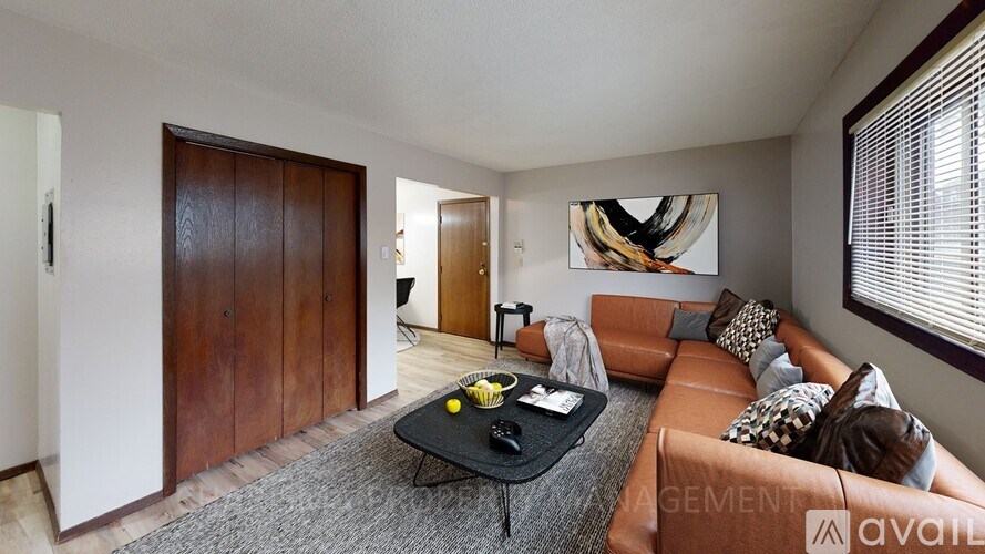 A living room with a brown couch and a coffee table.