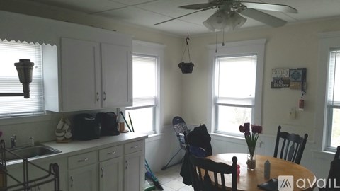 A kitchen with a table and chairs in the middle of the room.