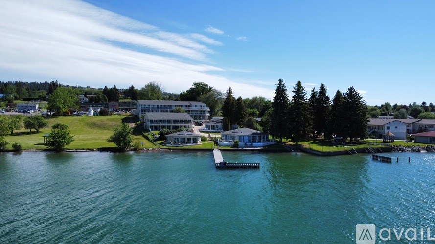 A body of water with a dock and a building in the background.