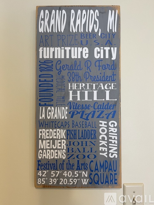 A sign with various words and phrases on it, including "Grand Rapids, MI", "Art Prize", and "Furniture City".