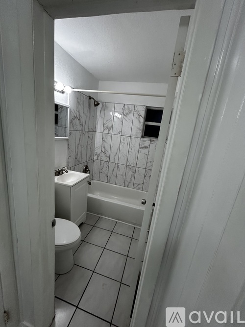 A bathroom with a toilet, sink and bathtub.