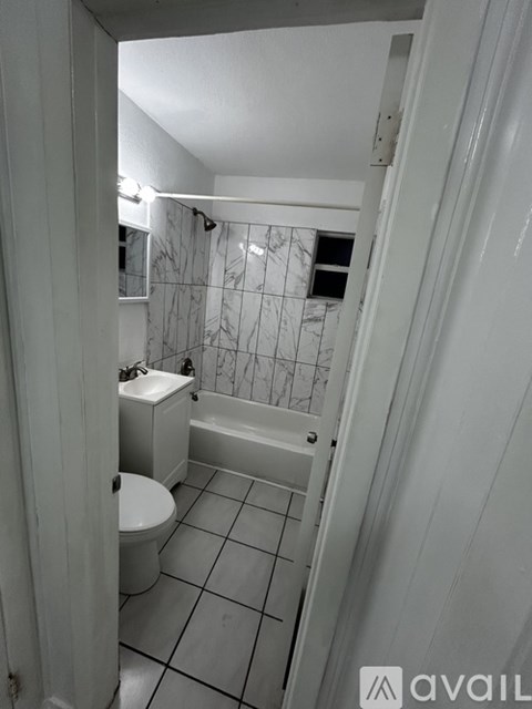 A bathroom with a toilet, sink and bathtub.