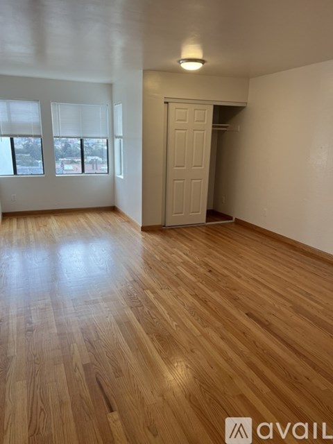 A room with wooden flooring and a white door.