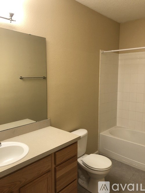 A bathroom with a toilet, sink, and bathtub.