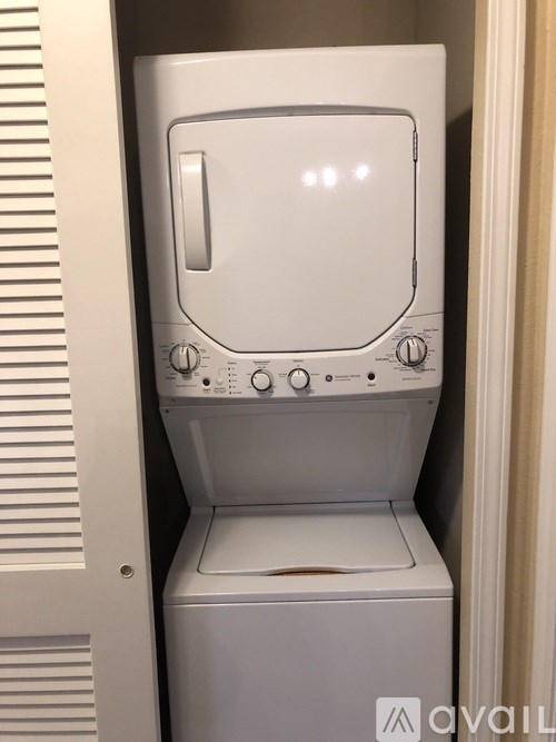 A white dryer is sitting in a doorway.