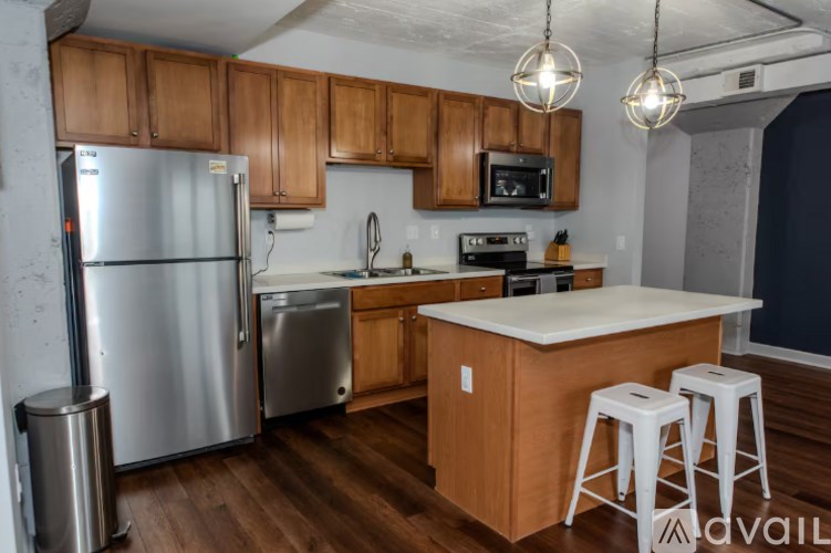 A kitchen with wooden cabinets and a white countertop.