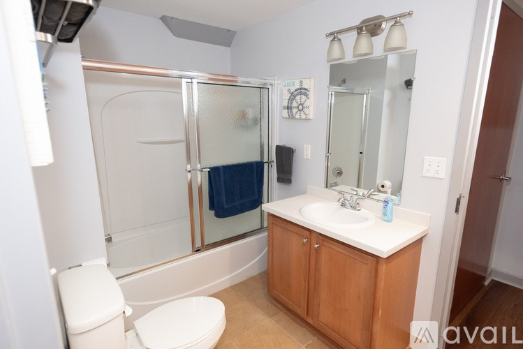 A bathroom with a toilet, sink, and shower.