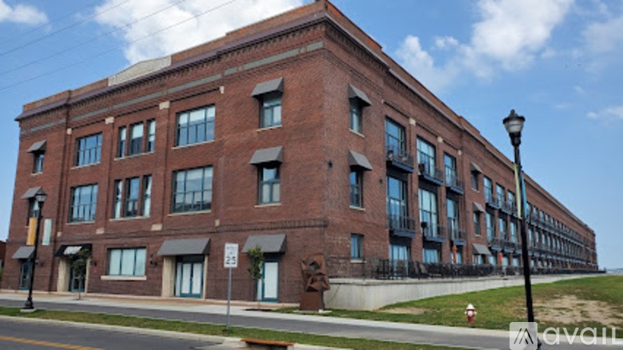 A red brick building with a black lamp post in front.