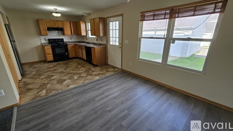 A kitchen with wooden cabinets and a black oven.