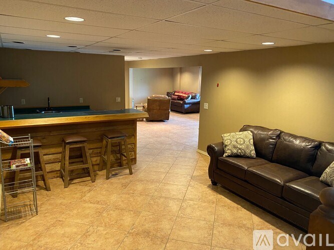A living room with a bar and couches.