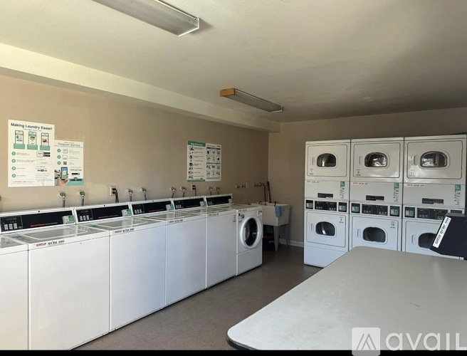 A laundromat with rows of washers and dryers.