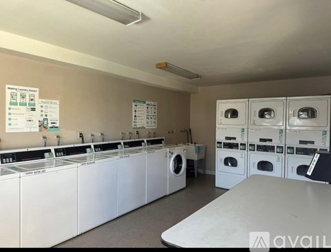 A laundromat with rows of washers and dryers.