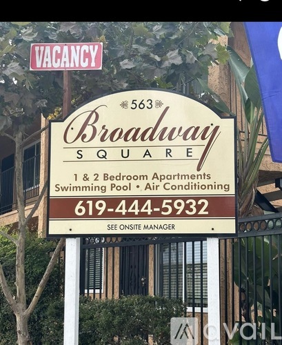 A sign for Broadway Square apartment complex with a phone number on it.