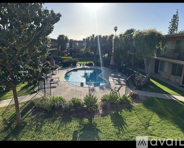 A sunny day at the pool with a fence around it.