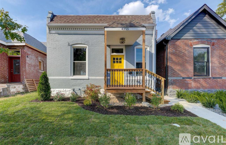 A house with a yellow door and a porch.