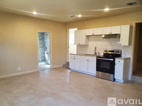 A kitchen with white cabinets and stainless steel appliances is available.