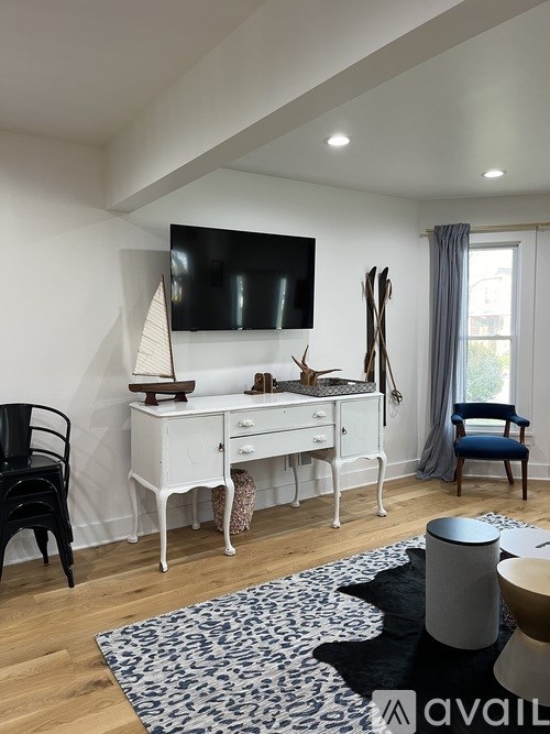 A room with a white desk and a black chair.