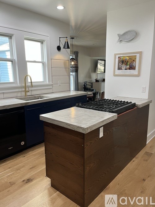 A kitchen with a wooden island and a fridge.