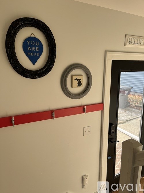 A wall with a mirror and a sign that says "You are here".