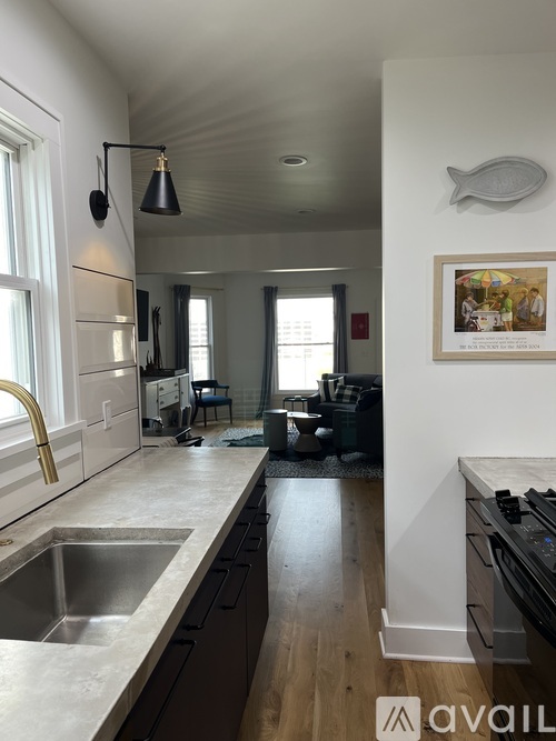 A kitchen with a sink and a fridge.