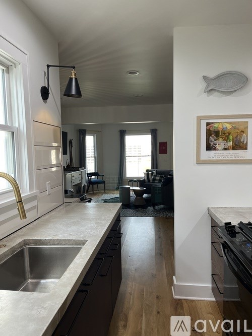 A kitchen with a sink and a fridge.