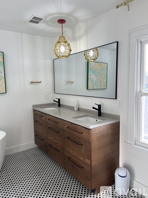 A bathroom with a sink, mirror, and a toilet.