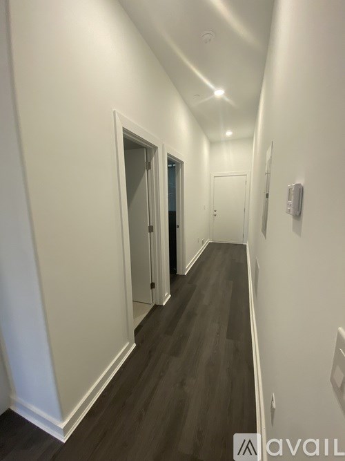 A long hallway with doors on both sides.