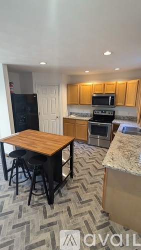 A kitchen with wooden cabinets and a granite countertop.