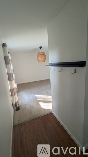 A bedroom with a bed, a ceiling fan, and a window with curtains.