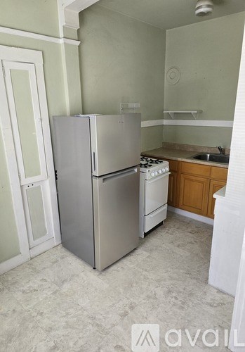 A kitchen with a refrigerator, dishwasher and sink.
