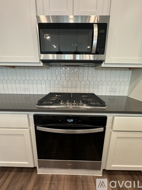 A modern kitchen with a stainless steel stove and oven.