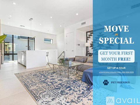 A modern living room with a blue rug and a glass table with a plant on it.