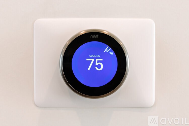 A nest thermostat displays a cooling setting of 75 degrees.