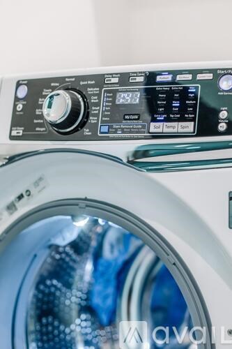 A washing machine with a digital display and control panel.