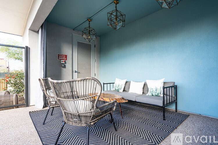 A living room with a sofa, chairs, and a coffee table.