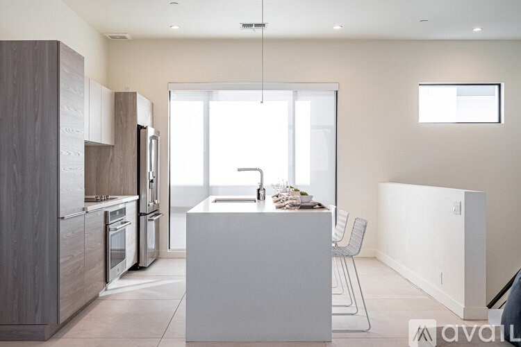 A modern kitchen with a white island in the middle.