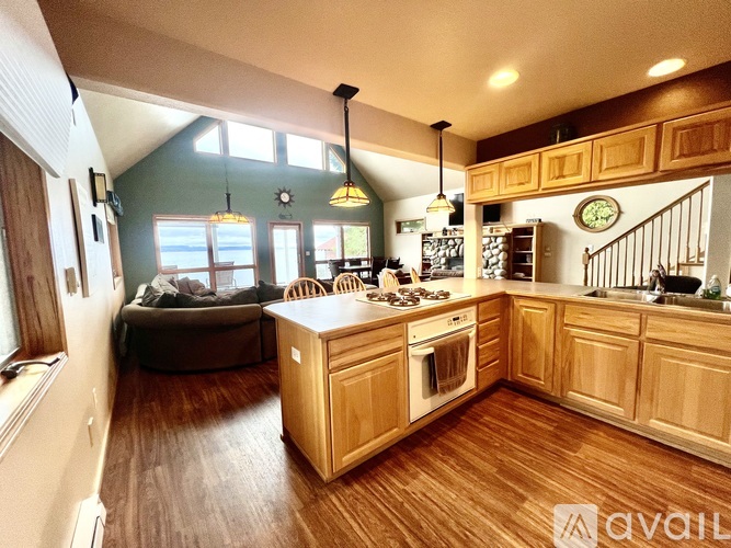 A kitchen with wooden cabinets and a large island.