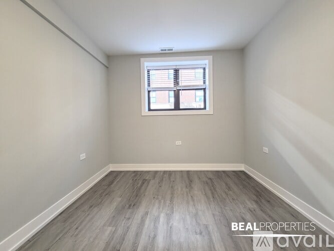 A room with a window and wooden flooring is available for rent.