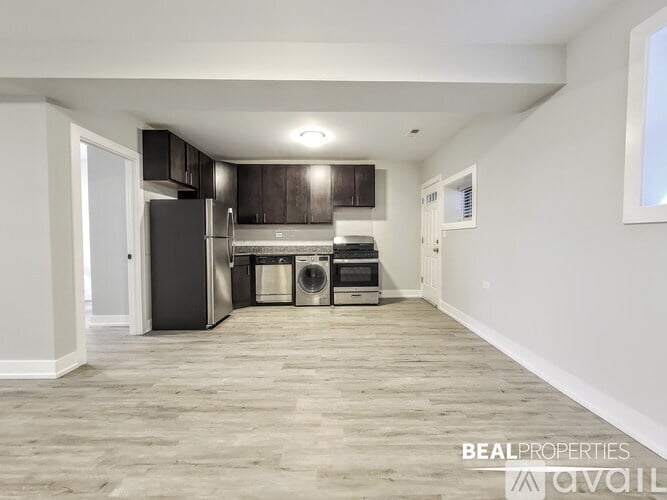 A spacious kitchen with dark wood cabinets and stainless steel appliances.