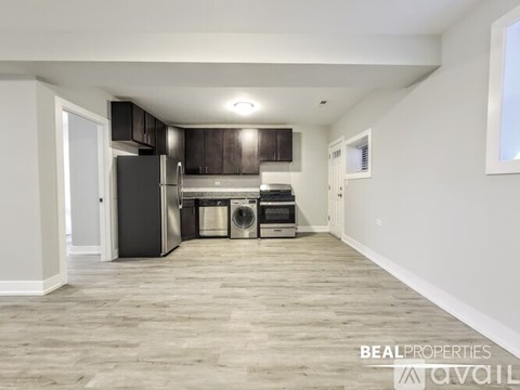 A spacious kitchen with dark wood cabinets and stainless steel appliances.